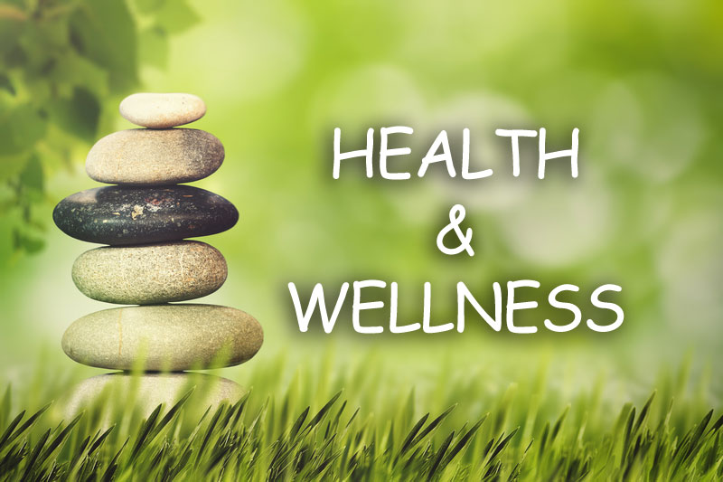 Picture of rocks stacked with the text Wellness